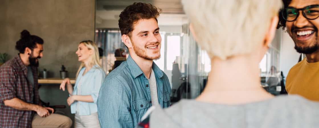 Young professionals mingle and talk in a coworking space