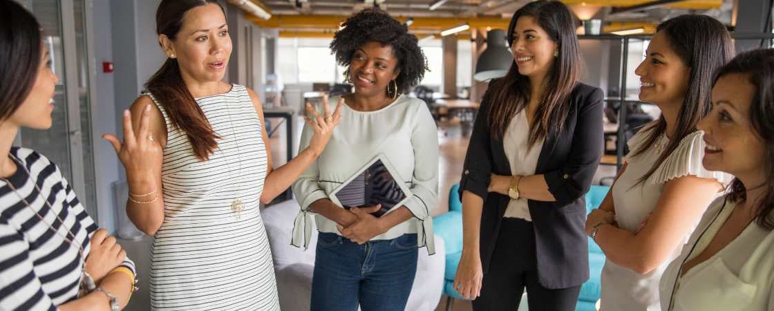 Professional women have a lively discussion in a coworking space 