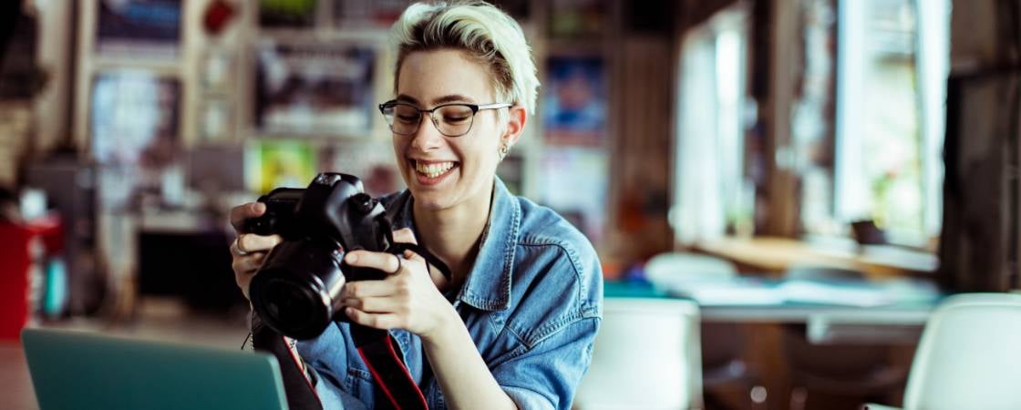 smiling young woman who is a photographer at a coworking space
