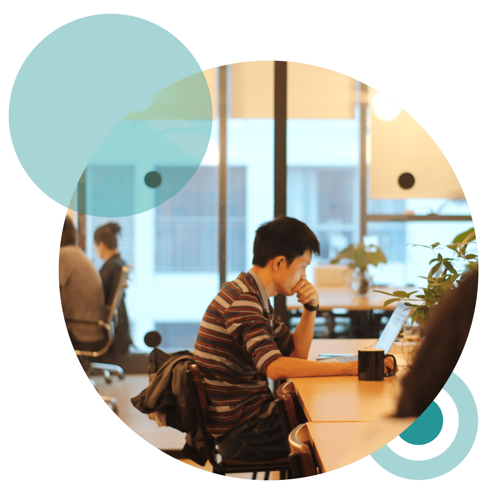 A man sits at a table in a growing coworking community